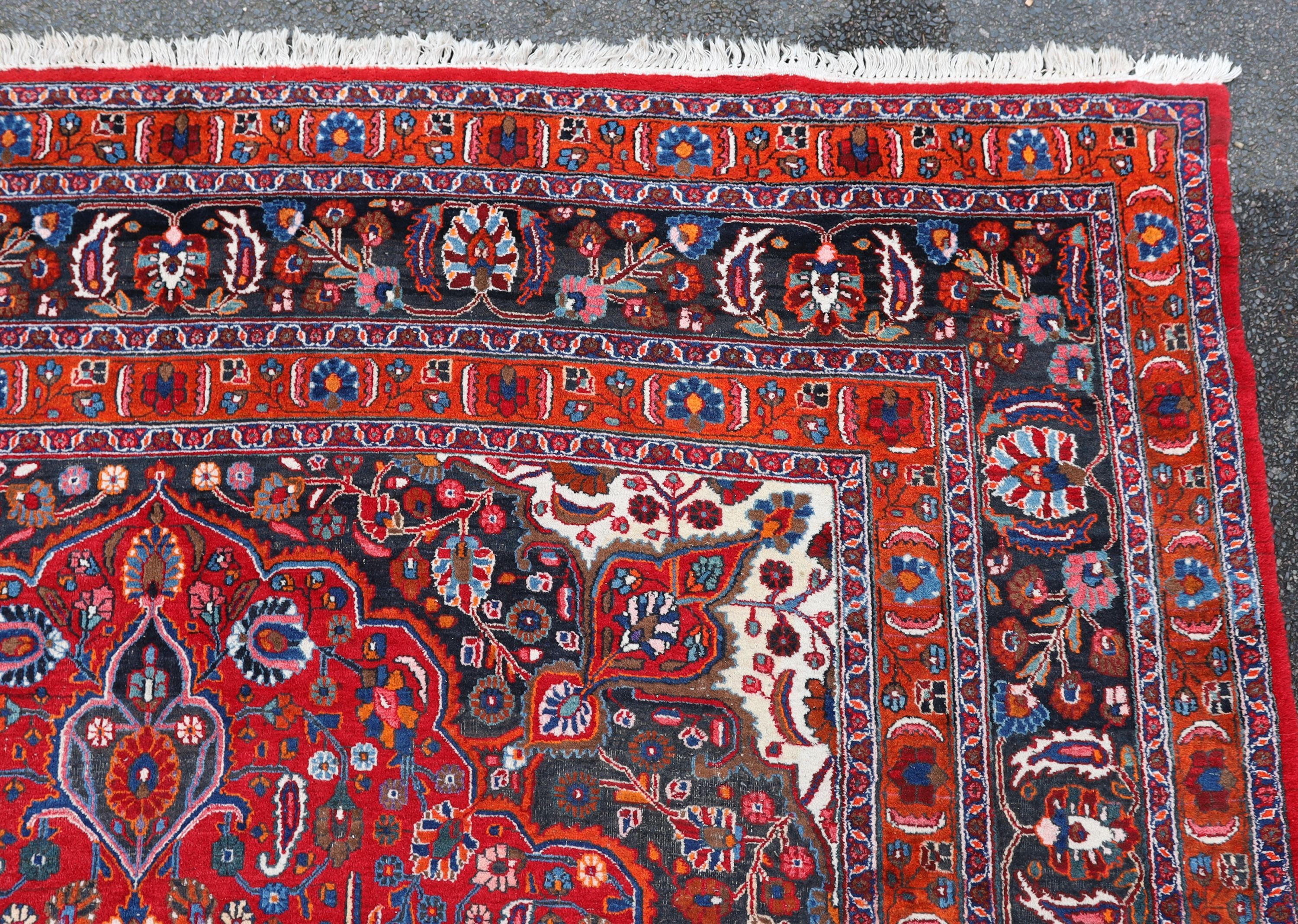 A Tabriz red ground carpet 422 x 326cm.